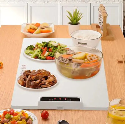 Fast Heating Food Electric Warming Tray with adjustable temperature controls, modern design, and food dishes on a dining table.