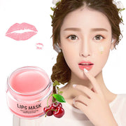 Moisturizing lip mask in pink jar with cherry illustrations, promoting hydration and nourishment.