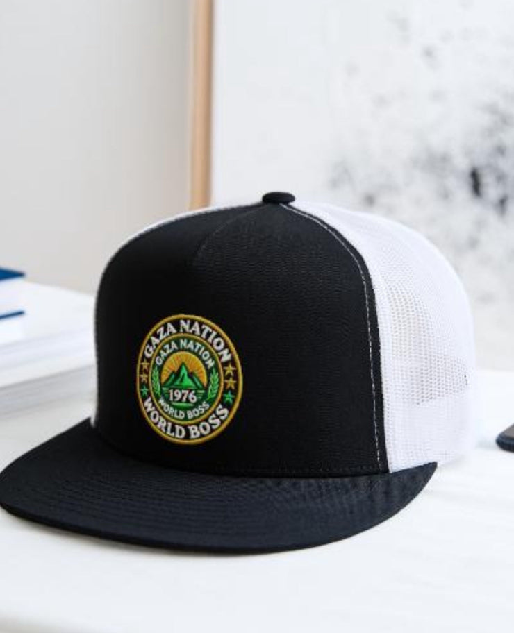 Gaza Nation Trucker Hat with World Boss logo on a table.