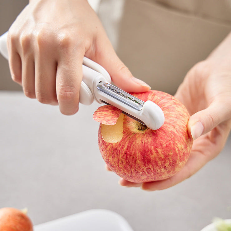 3-in-1 rotating stainless steel peeler used to peel an apple.