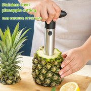 Stainless steel pineapple slicer in use for easy pulp extraction.