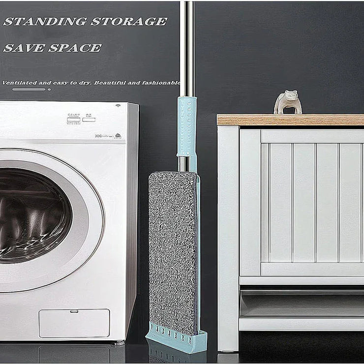 Newest Microfiber Flat Mop with washable pad standing upright for easy storage beside a washing machine.