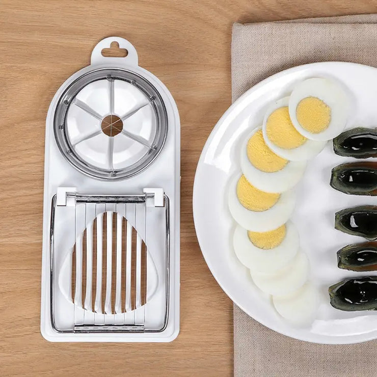 Multifunctional steel egg slicer with dual cutting tools and sliced eggs on a plate.