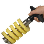 Stainless steel pineapple slicer peeling multiple pineapple rings.