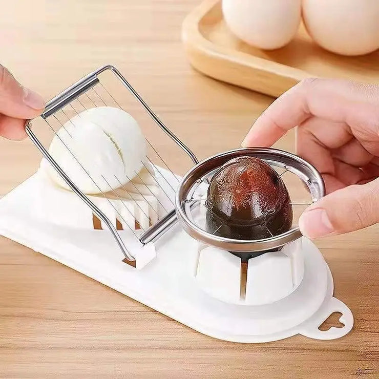 Stainless steel egg slicer and splitter in use on a countertop.