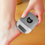 Electric foot rasp with digital display being used for callus removal on heel.