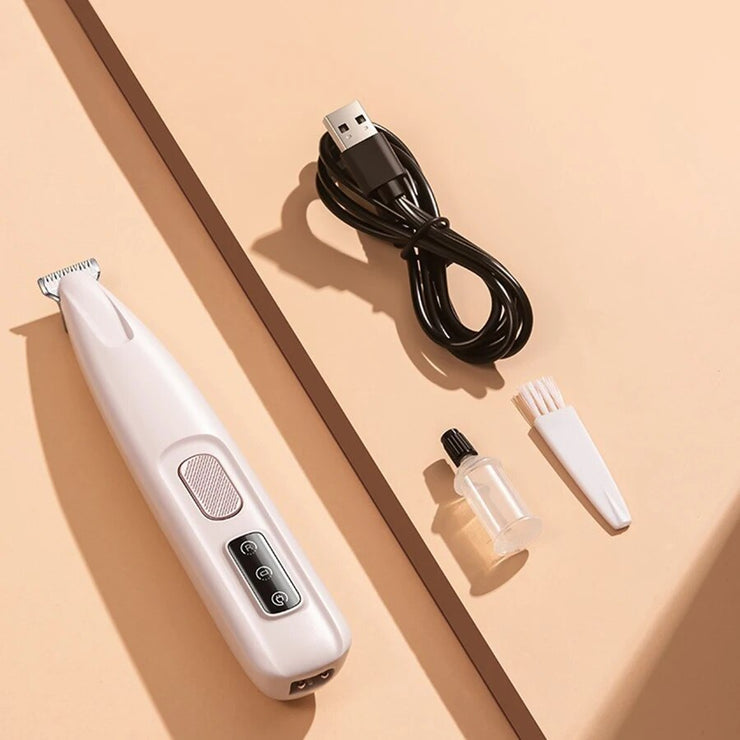 Dog paw trimmer with LED light and accessories including charging cable, lubricating oil, and brush on a beige background.