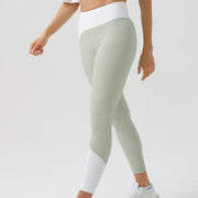 Eco-friendly yoga pants in light green with white accents and irregular design, suitable for fitness and sports.